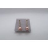 A pair of 9ct yellow gold pink cultured pearl drop earrings with long bales set with diamonds, boxed