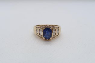 A good sapphire and diamond ring - The central oval sapphire approx 8mmm x 6mm with 14 baguette