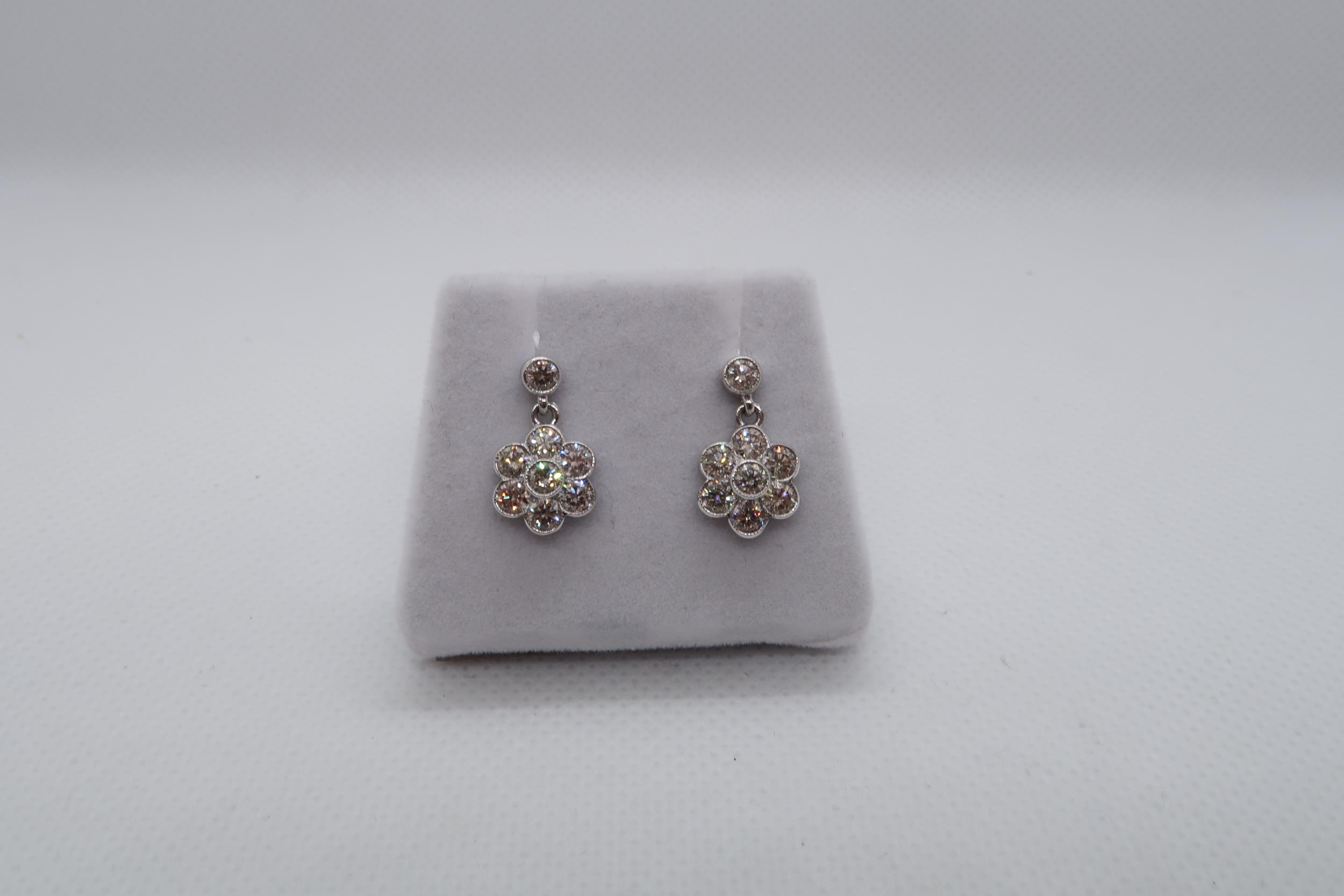 A pair of 18ct white gold daisy style diamond set cluster drop earrings, boxed - round brilliant cut