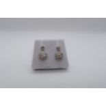 A pair of 18ct white gold daisy style diamond set cluster drop earrings, boxed - round brilliant cut