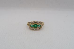 An 18ct yellow gold emerald and diamond ring - emeralds are a good colour, well matched with natural