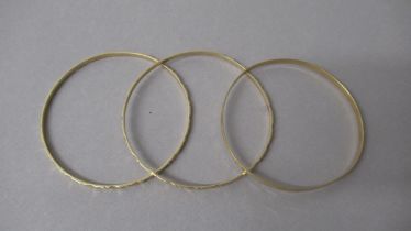 Three 18ct (hallmarked) yellow gold bangles - approx 7cm diameter - approx total weight 29.5 grams