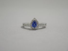 An 18ct white gold pear shaped sapphire and diamond ring, diamonds are well matched and bright and