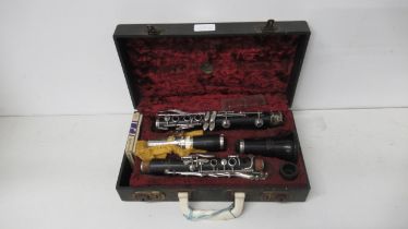 A Boosey & Hawkes clarinet in fitted leather case, complete with accessories