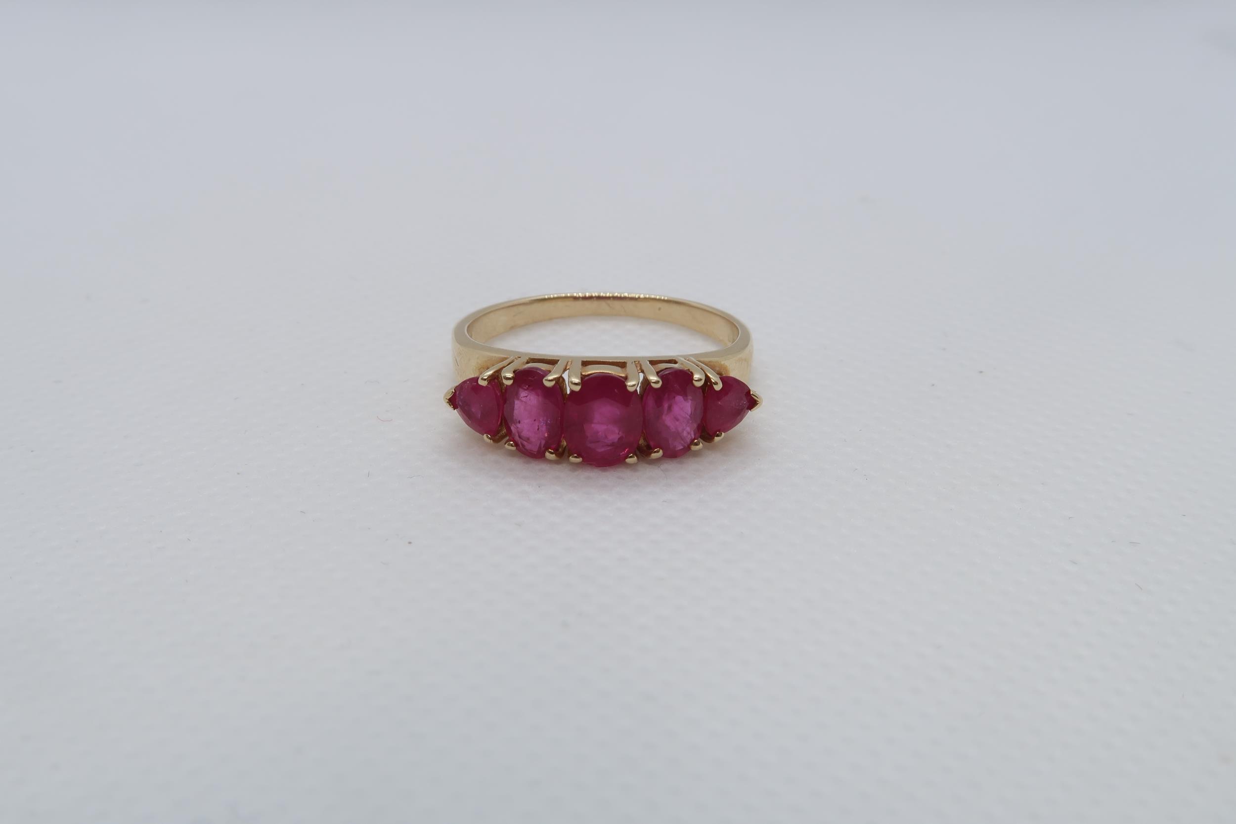 A 14ct yellow gold (hallmarked) and ruby five stone bridge ring size R/S - weight approx 3.7 grams