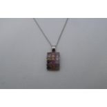 A 9ct white gold (hallmarked) pendant with coloured stones - 3cm (in ring) approx weight 5 grams -