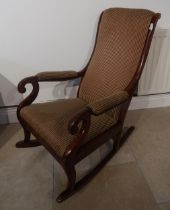 A good quality Victorian mahogany rocking chair upholstered in a stripe fabric - in good condition