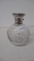 A silver topped cut glass bottle with tortoiseshell and stopper, Birmingham 1928 - good overall