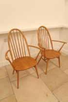 A pair of light Ercol armchairs