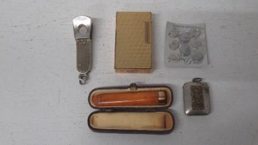 A gold plated DuPont cigarette lighter, a silver cigar with another and an amber cheroot holder with