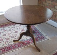 A 19th century oak tripod table - top diameter 86cm