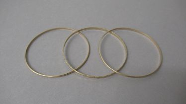 Three yellow gold bangles tested as approx 9ct gold - diameter 6.5cm - total weight approx 16.5