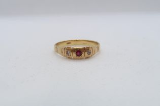 An 18ct yellow gold (hallmarked) ring with diamonds and ruby - ring size V - approx weight 4.6 grams