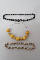 Three necklaces, one amber, one Venetian glass