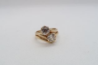 An impressive diamond two stone crossover ring - The old cut round diamonds assessed as 0.90ct and