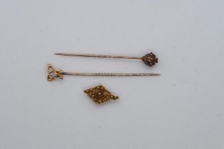 Two gold tie pins, both marked 15ct one with diamond and a gold button (tested) 4 grams