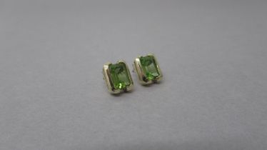 A pair of 9ct yellow gold peridot earrings - peridots are well matched - total weight of peridots