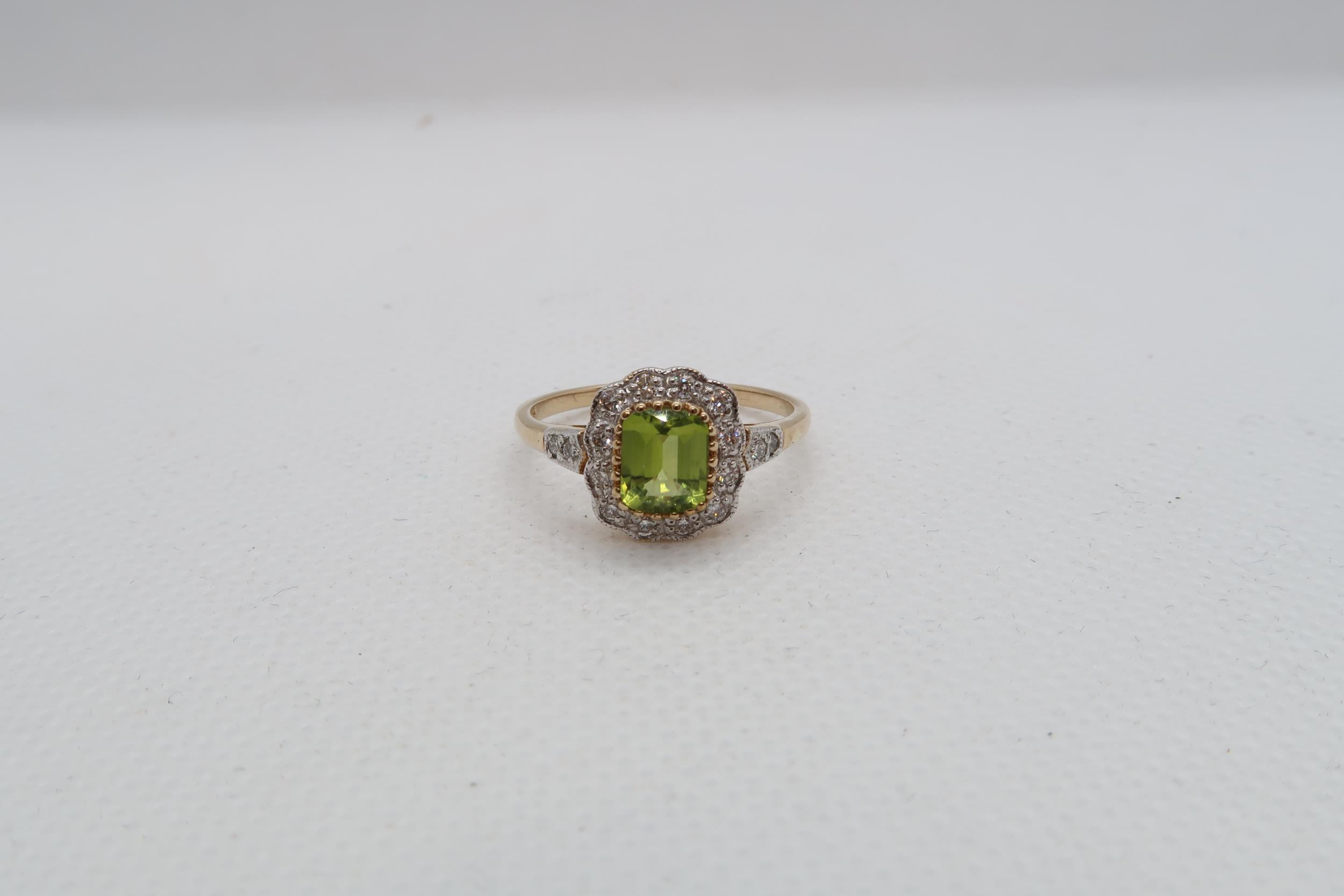 A 9ct yellow gold Peridot and diamond ring with diamond shoulders - head size approx 11mm x 11mm -