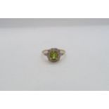 A 9ct yellow gold Peridot and diamond ring with diamond shoulders - head size approx 11mm x 11mm -