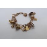 A 9ct (hallmarked) charm bracelet - 13 charms - approx weight 26 grams