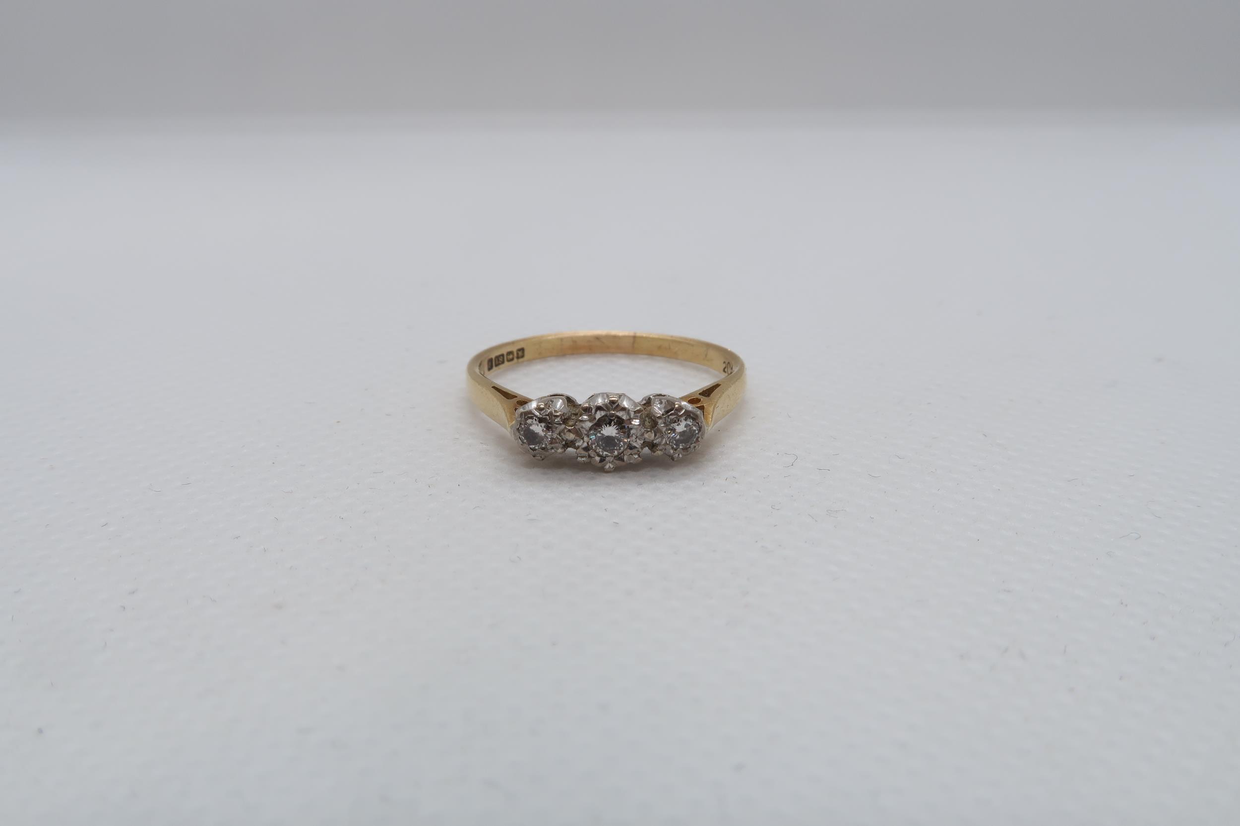 An 18ct yellow gold (hallmarked) three stone diamond ring size R - weight approx 2.8 grams