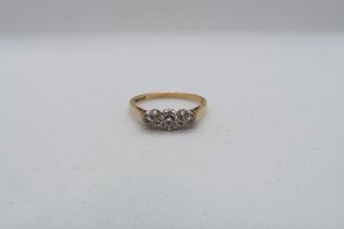 An 18ct yellow gold (hallmarked) three stone diamond ring size R - weight approx 2.8 grams