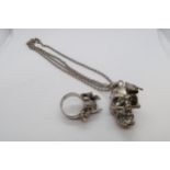 An Alexander McQueen skull pendant on chain, pendant 3cm, together with an Alexander McQueen ring,