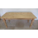 A good quality modern pine table on turned legs, 170cm wide x 76cm x 76cm high