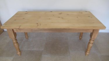 A good quality modern pine table on turned legs, 170cm wide x 76cm x 76cm high