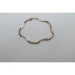 An approx 9ct (tested) bi-colour section bracelet with diamond accents, 18.5cm long, approx 5.3