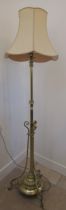 A good quality brass lamp with adjustable height on three outswept legs, 190cm high