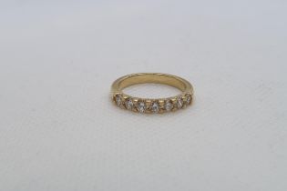 A diamond seven stone half eternity ring set in 18ct (hallmarked) yellow gold with accompanying