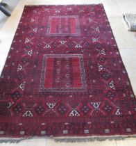 An Eastern hand knotted red ground rug - 150cm x 255cm