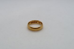 A 22ct (hallmarked) yellow gold band ring size J - approx weight 6.3 grams