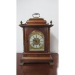 A Lenzkirch mahogany architectural 8 day mantel clock with brass dial on four brass feet with