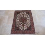 A hand knotted woollen Tabriz rug - 1.40m x 1.02m