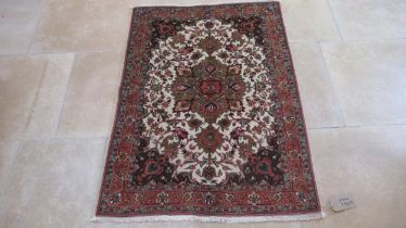 A hand knotted woollen Tabriz rug - 1.40m x 1.02m