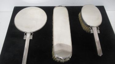 A set of silver Georg Jensen hairbrush, mirror and clothes brush - in good condition