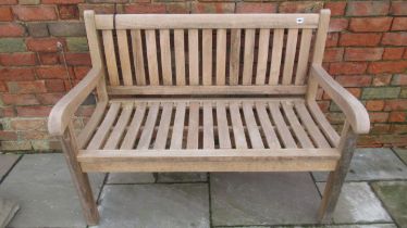 A weathered teak garden bench, sound condition and well made, 120cm wide