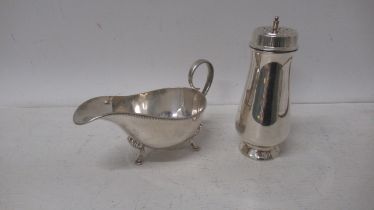 A silver sugar sifter, Garrard & Co Birmingham 1963 - 15cm - together with silver sauce boat -