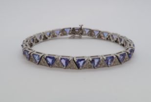 A stunning Art Deco style tanzanite and alternating diamond line bracelet -