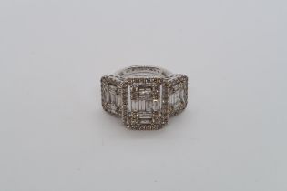 A certified large triple cluster ring set with baguette and round brilliant cut diamonds set in