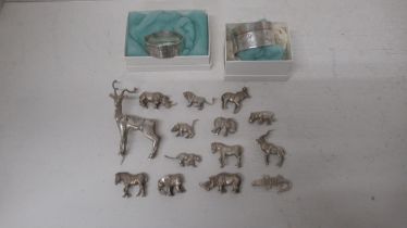 A collection of silver (tested) figures of animals (14) together with 2 x silver hallmarked napkin
