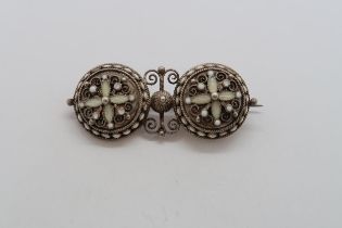 A silver hallmarked filigree and white enamel brooch, 4cm
