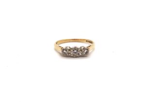 an 18ct yellow gold hallmarked three stone diamond ring, size R, approx 2.8 grams