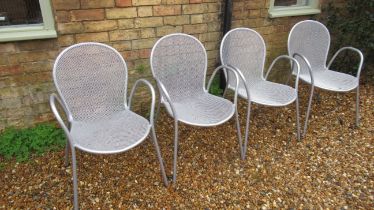 A set of four metal garden chairs