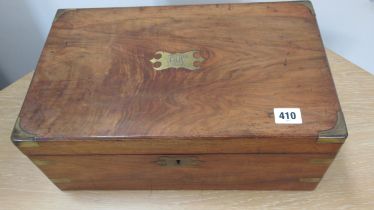 A 19th century walnut writing slope with brass inlay and corners