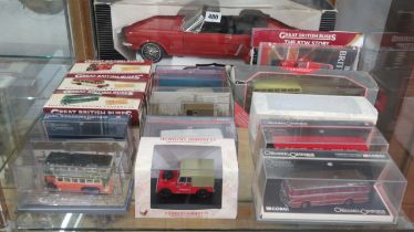 A 1964 Ford Mustang 1:12 scale diecast model car together with others