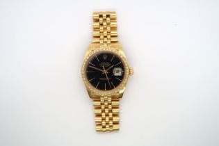 A gents Rolex Datejust in 18ct yellow gold, black dial with diamond bezel, with Rolex 18ct