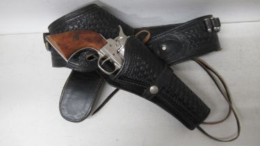 A modern Western style holster rig with nickel plated non firing replica Colt SA .45 - well made